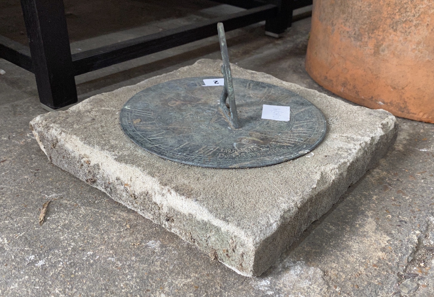 A circular metal and reconstituted stone sun dial, width 30cm